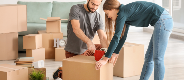 Couple packing cardboard boxes